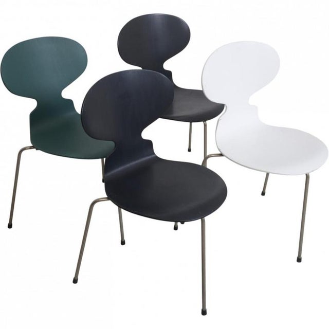 Set of four Arne Jacobsen Ant chairs with a firm back and chrome legs. The chairs are from the 1970s but have been...