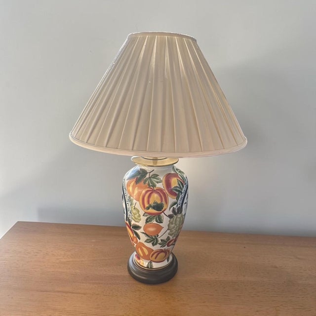 A stunning, oversized vintage chinoiserie porcelain table lamp featuring vibrant botanical and fruit decoration,...