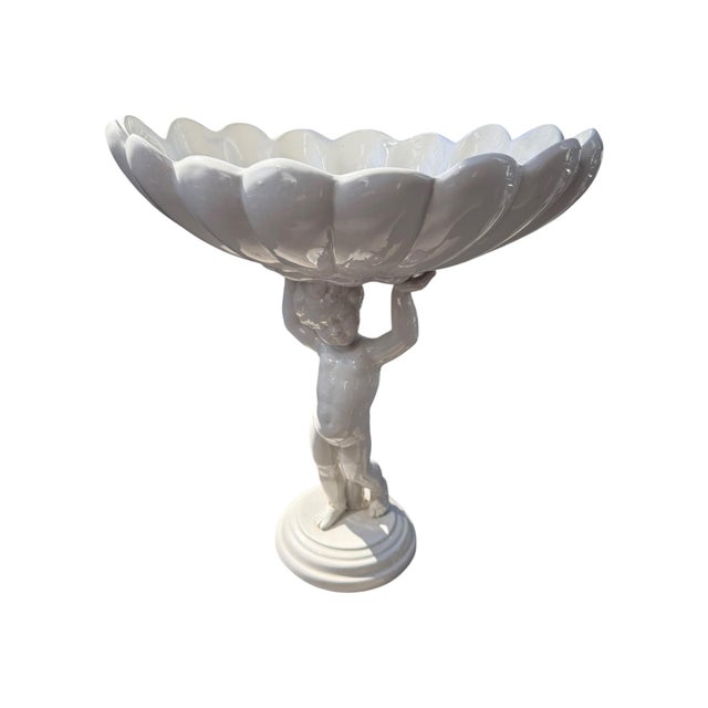 Beautiful vintage Italian white ceramic figural compote/centerpiece featuring a sculptural putto (cherub) supporting a...