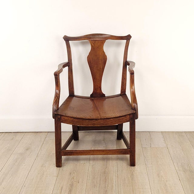 An English oak armchair with saddle seat, 19th century or earlier. Seat height 13.5".