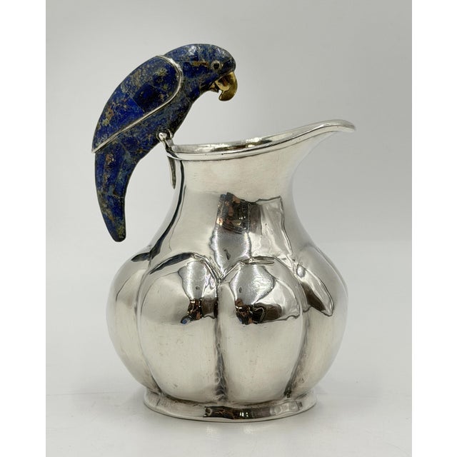 A superb 1970s Mexican Modernist silver-plated brass pitcher by Los Castillo of Taxco, distinguished by its sculptural...