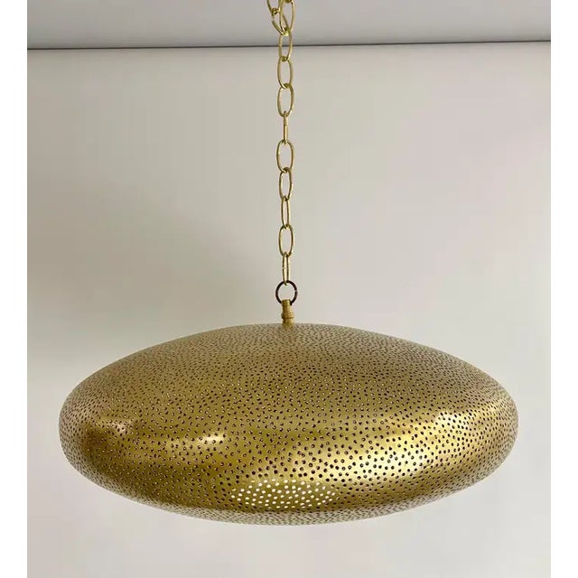 A Mid-Century Modern style all brass pendant or lantern. Featuring a spaceship oval shape, this stylish pendant is...