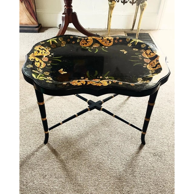 A gorgeous painted tole tray on stand. The black and gold is stunning with the flowers and butterflies. This has such a...