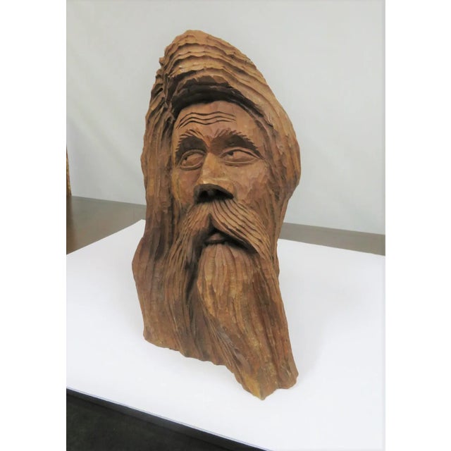 Mid Century Modern Art chip carved bust of an old man with flowing hair and beard , carved out of a solid piece of wood .