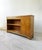 Refined low vintage bookcase in walnut burl, featuring a beautiful natural grain in warm, luminous tones. The piece...