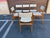 Great set of 6 teak dining chairs designed by Johannes Andersen for Uldum mobelfabrik. These Danish modern teak chairs are...