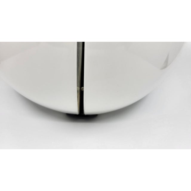 This elegantly designed wall light is distinguished by its circular chrome metal plate, which supports two partially open...