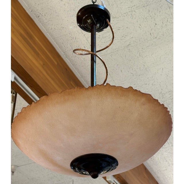 Design Plus Gallery presents the Textured Amber Bowl Pendant by Lightspann Illumination Design. A broad, amber-toned shade...