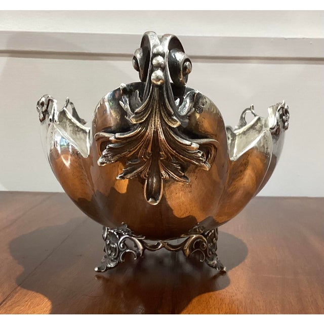 A jardinier centerpiece in solid 800 silver, chiseled and shaped like a boat. It features finely decorated handles and...