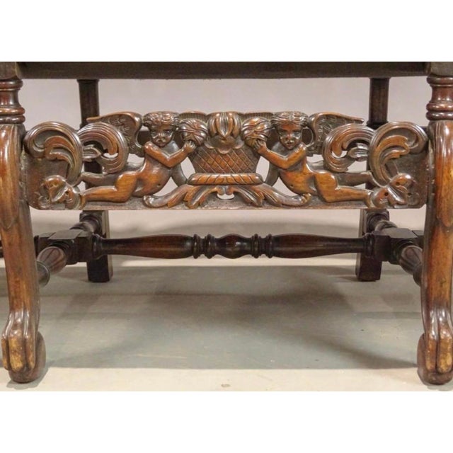 A mid 20th century Jacobean Revival Style three-seat settee, finely crafted in richly patinated hardwood and displaying...