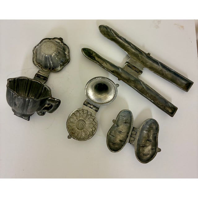 4 vintage pewter molds. Cup, daisy, potato, asparagus. Two of the molds have LG impressed i the pewter.