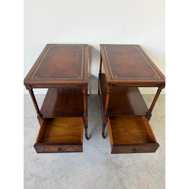 A sophisticated pair of 1960s Weiman Heirloom Quality end tables, masterfully crafted in rich mahogany and featuring...