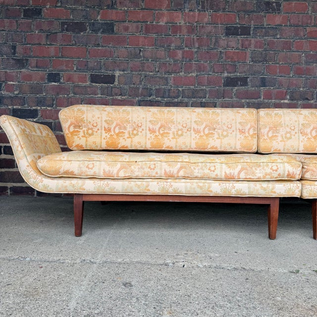Striking mid-century gondola-form sofa attributed to Edward Wormley for Dunbar, featuring a sculptural floating back and...
