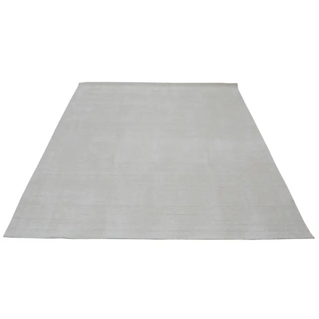 Modern hand loom rug with minimalist design.