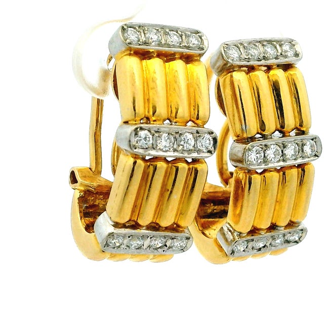 Striking vintage clip earrings by Italian maker TRIO, crafted in 18K yellow gold with contrasting white gold diamond...