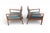 A handsome matched pair of walnut lounge chairs from the United States, 1960s. Clean lines, walnut frames, and a low,...
