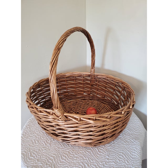 Iconic classical European style vintage Market Baskets. The large sized basket has a warm cinnamon tone and the medium...
