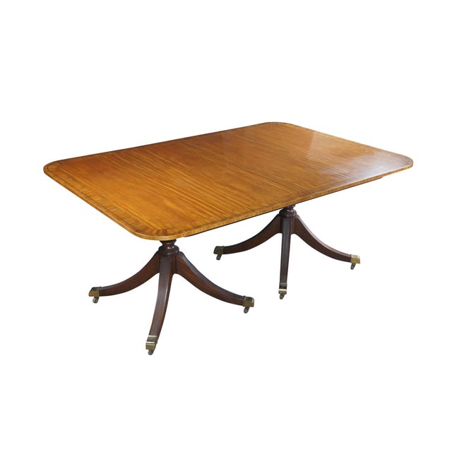 Baker Furniture Collectors Edition English Regency Duncan Phyfe dining table. Features an impressive satinwood cross...