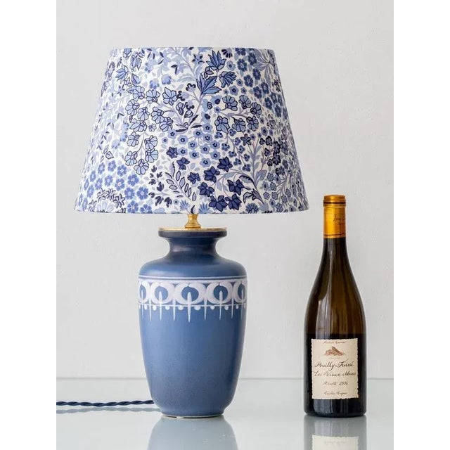 This vintage table lamp features a hand-painted ceramic base produced by Flora Gouda in 1977 during the final years of the...