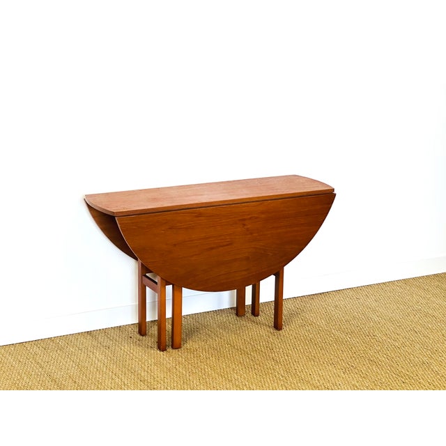 Scandinavian folding teak dining table. round table ideal for small spaces. dimensions: h75 d122 lr1: 79.5 p41