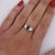 0.57 Carat Emerald-Cut Natural Green Emerald with Emerald-Cut Diamond Side Stones in Platinum 850 Three-Stone Engagement...