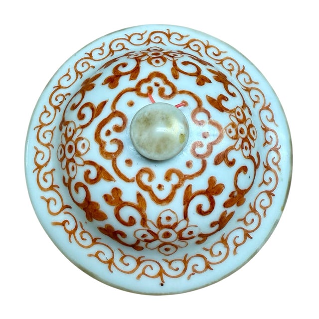 A porcelain teapot from the late Qing dynasty, Tongzhi period. Traditional iron red foilate design with lappet border,...