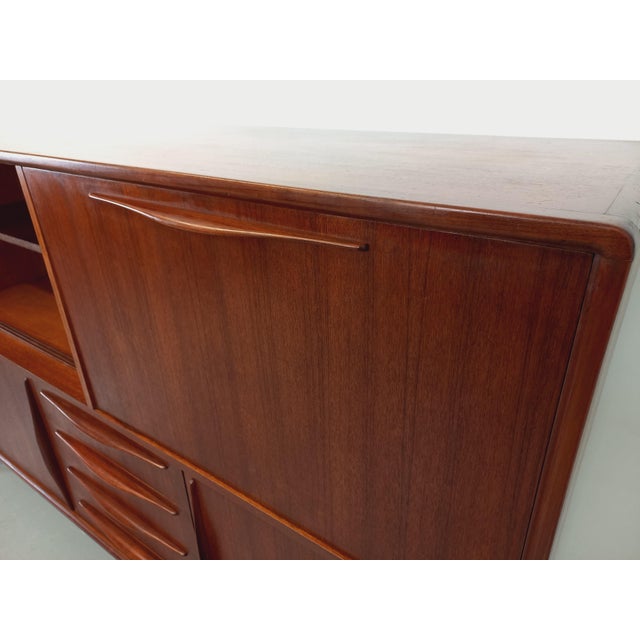 Scandinavian high sideboard from the 50s and 60s in teak, very beautiful work of the handles and feet and beautiful...