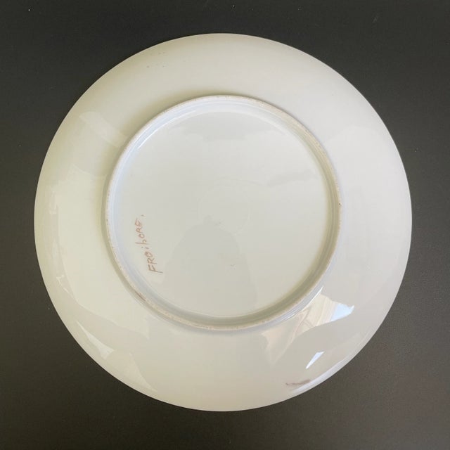 An Art Nouveau Nippon era hand painted yellow camellias with leaves cabinet plate, accented with gold gilt border. Artist...