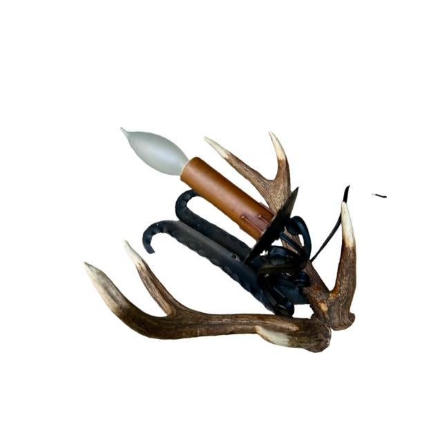 Antler wall sconce. A nice piece for your mountain home. Roe dder antles on a piece of hammered iron.