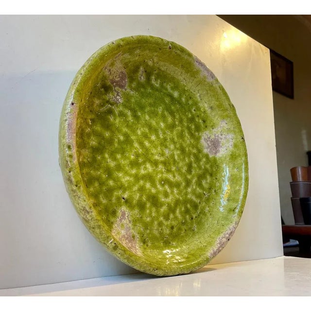 Large and heavy centerpiece bowl/dish. Its Raku fired and is decorated with a vibrant green crackle glaze with intended...