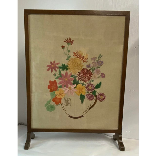 Lovely mid century embroidered fire screen featuring a basket of flowers.