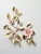A pair of vintage brass wall sculptures depicting flowering branches with hand-painted porcelain or resin blossoms in soft...