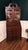 This is a Colonial Revival secretary desk featuring tall double glass doors. It is designed with ball and claw feet and a...