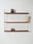 Scandinavian teak shelving system from the 1960s and 1970s, with white-painted metal uprights and adjustable shelves with...