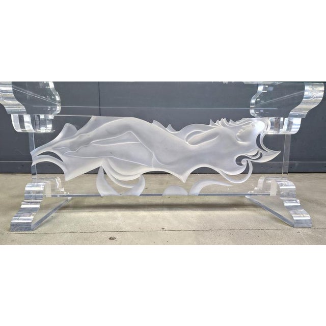 Acrylic coffee table with a 3d sculpture depicting a laying woman. Topped off with a rectangular table top. 1980s - Italy...