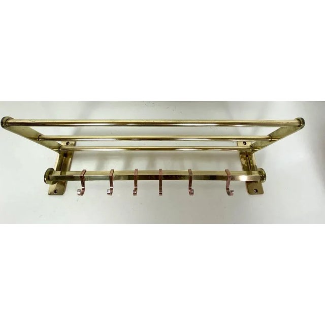 Old French wall coat rack in a beautiful design, two tone brass, with a hat shelf. The brass is of a good quality and has...