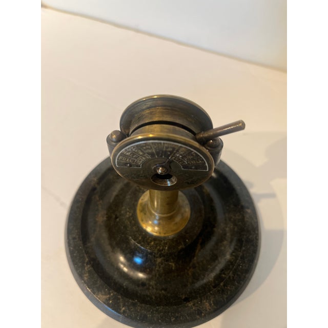 Early 20th Century German Cigar Cutter & Marble Base Ashtray. Brass pedestal column, a dual sided dial marked with...