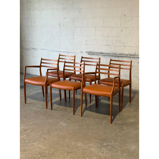This set of six dining chairs features an elegant organic profile with sculpted slatted backrests. It includes four...