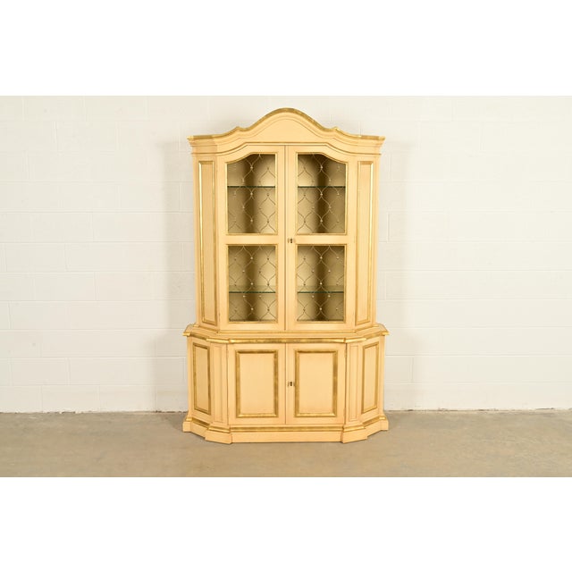 A beautiful French Regency Louis XV style breakfront bookcase or dining cabinet In the manner of Karges USA, Circa 1960s...