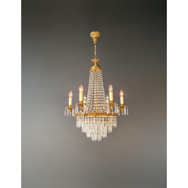 This elegant crystal chandelier has been fully restored in our Berlin workshop with great care and attention to detail....