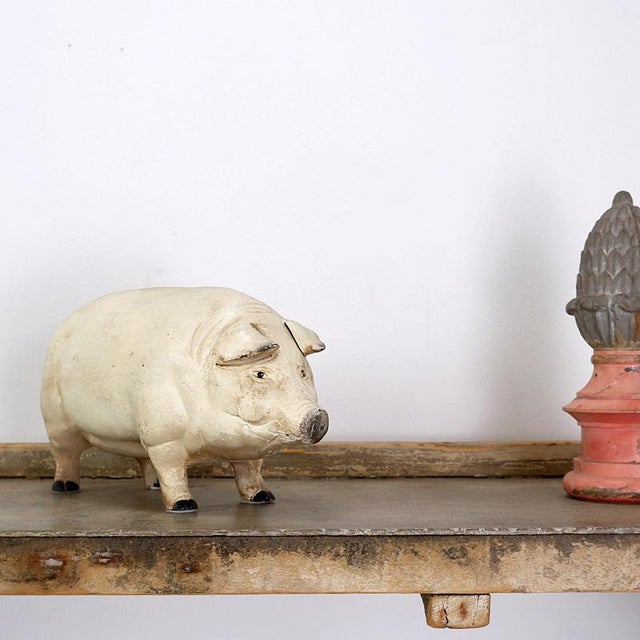 This one-piece cast cast iron piggy bank stood in a butcher shop since the late 1950s. Goal was to raise money for...