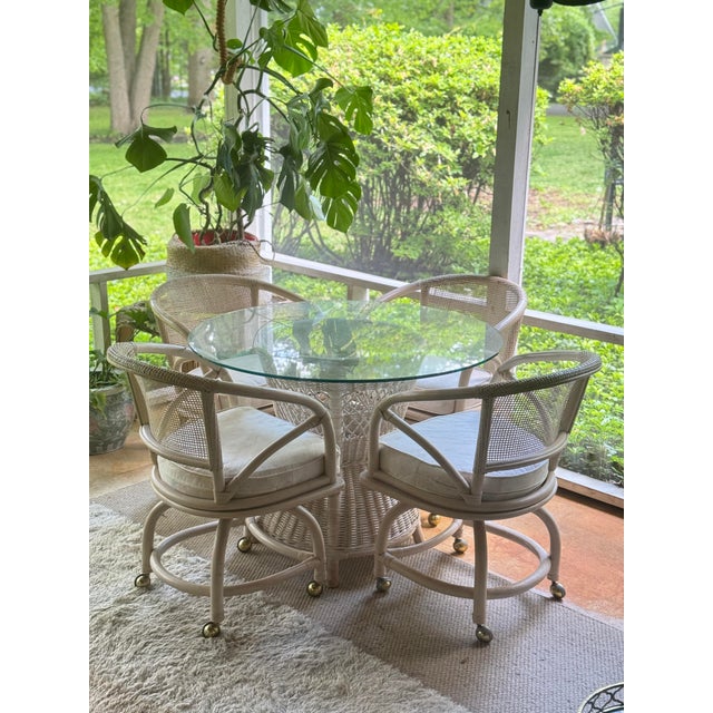 Chairs are on wheels and feature removable cushions. The table comes with a removable tempered glass top 40" in diameter,...