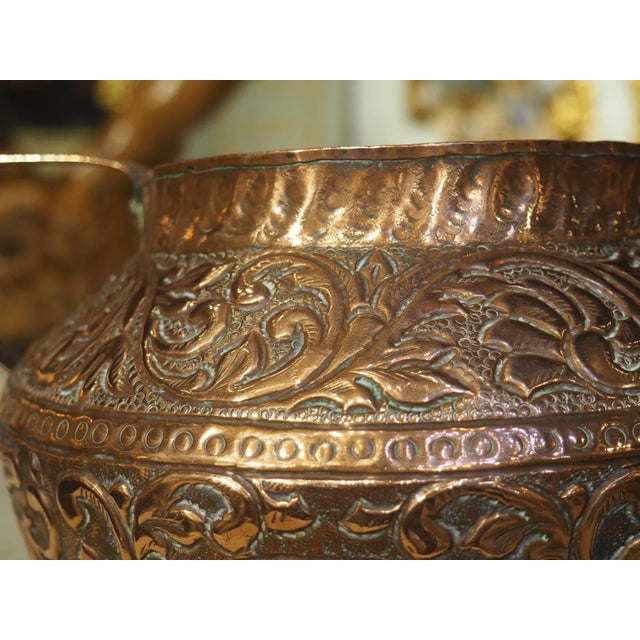 Hand-worked circa 1800, this French vase is adorned with a chariot and cartouche scene. Some of the elements were hammered...