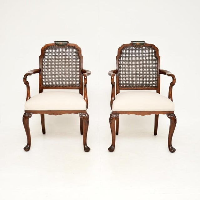 A beautiful pair of antique Edwardian lacquered walnut and cane armchairs. They were made in England, they date from...