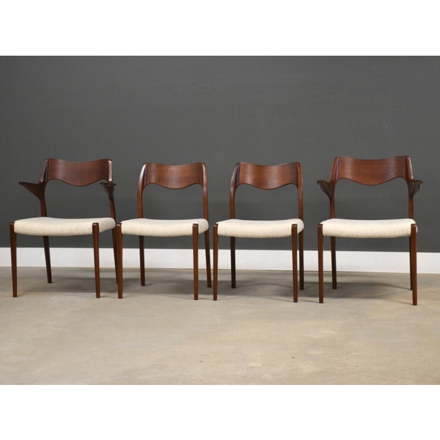 A set of four mid century modern teak model 55 and 71 dining chairs by Niels Moller. Made in Denmark. Professionally...