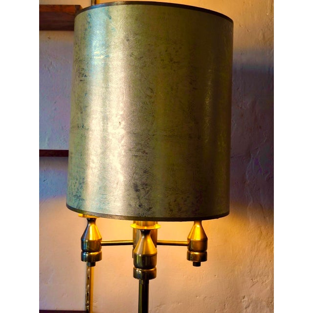 Impressive and unusual Brutalist floor lamp in brass or bronze with its original cylindrical shade in mottled gold color....