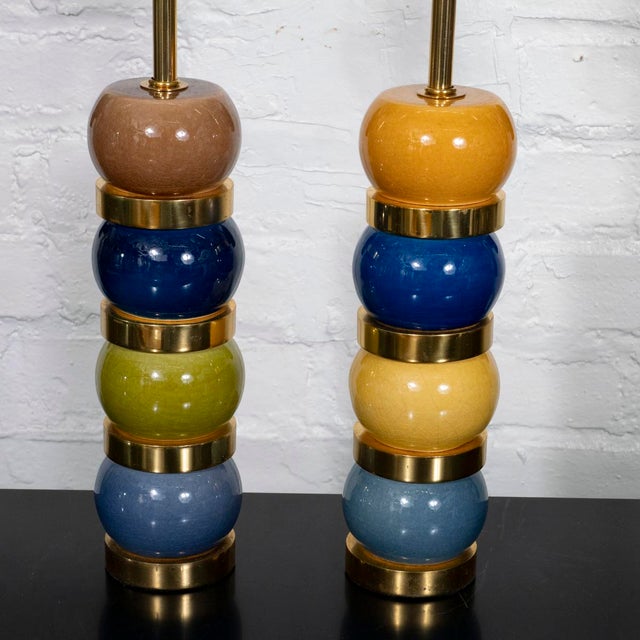 Pair of multicolored stacked ceramic element and brass table lamps
