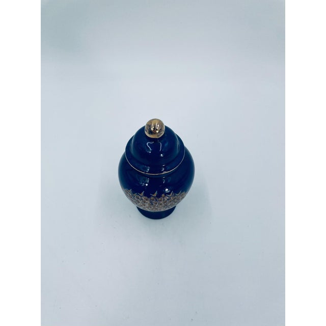 Japanese ginger jar, crafted from high-quality porcelain. The deep cobalt blue jar features a matching lid with a gold...
