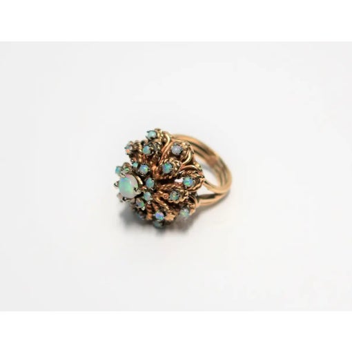 A very beautiful and substantial vintage opal gemstone and 14-Karat yellow gold cluster cocktail ring, circa 1960s. Ring...