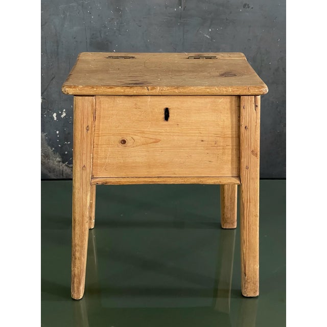 Rusticly simple 19th Century English pine stool with storage. Well constructed including a lock mechanism.